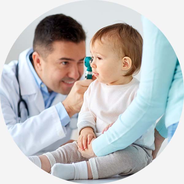 Doctor inspecting babies ear